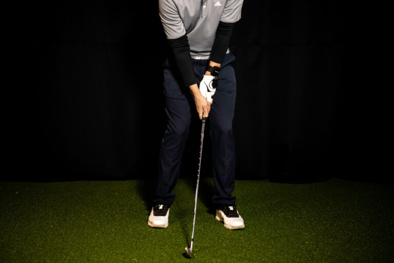 golf player training with iron at home